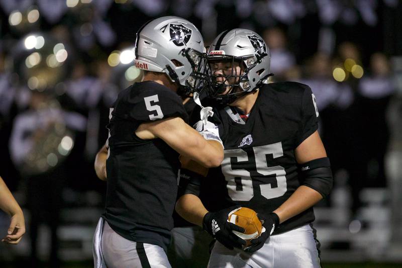 Kaneland's Brett Larson (65) celebrates a touchdown by recovirng a loose ball against Ottawa with Josh Mauthe(5)  on Friday, Sept. 22, 2023 in Maple Park.