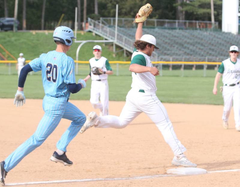 St. Bede's Alan Spencer steps on first base to force out Marquette's Charlie Mullen on Monday, April 22, 2024 at St. Bede Academy.