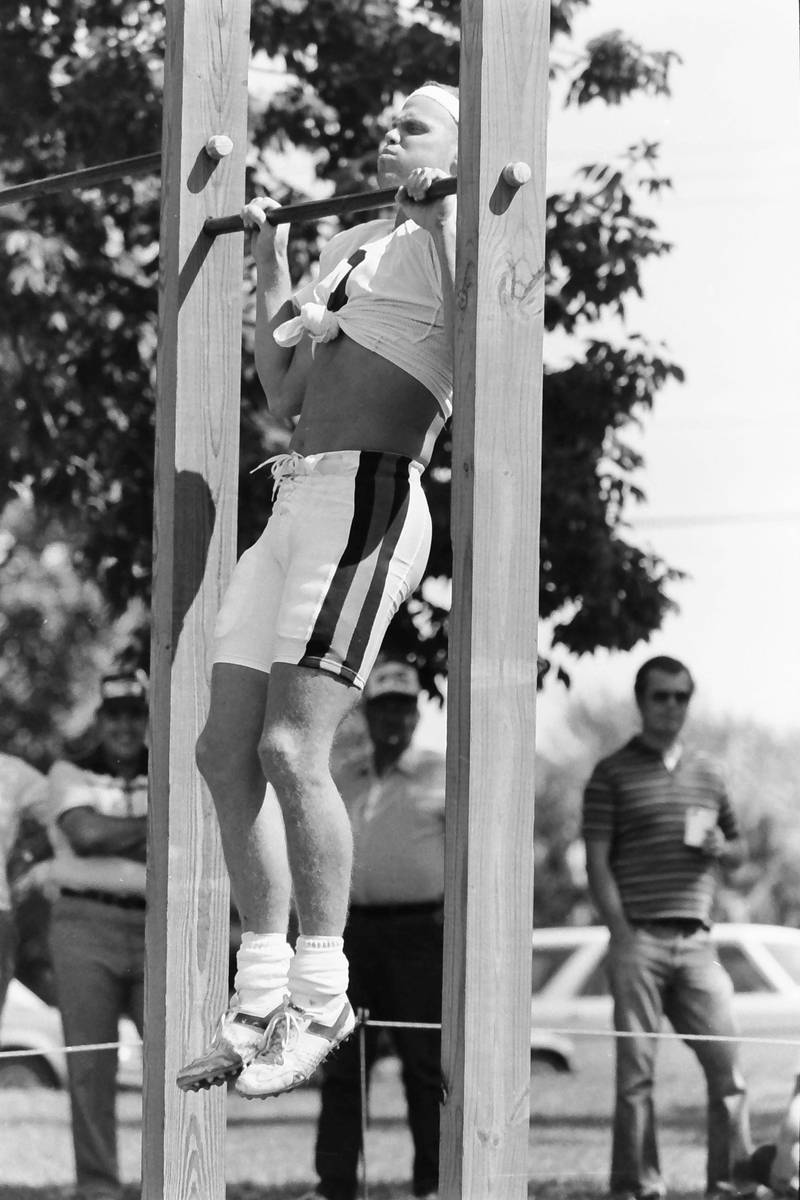 Chicago Bears quarterback Jim McMahon does pullups during training camp on Wednesday, June 12, 1985 in Platteville Wis.