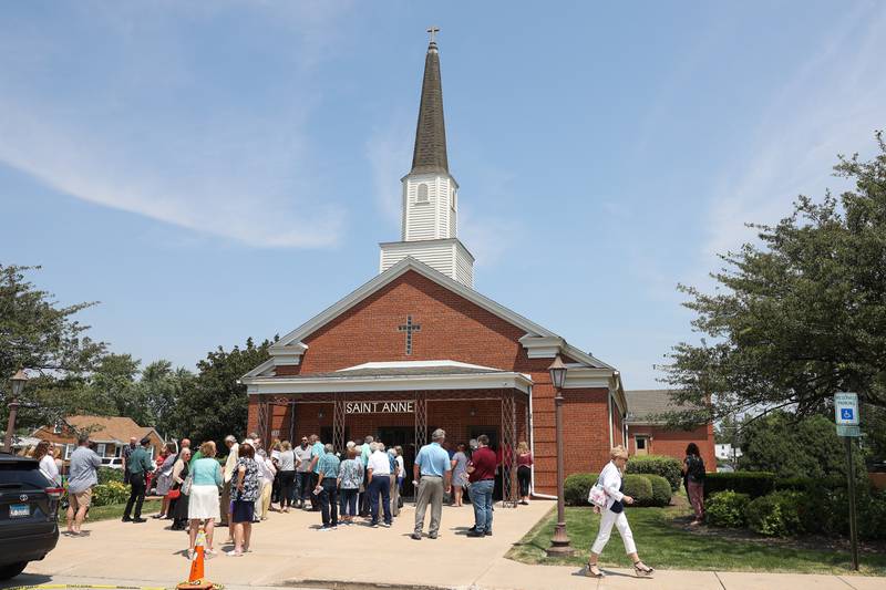 People gather and fellowship outside Saint Anne after the final mass on June 16, 2024 in Crest Hill.