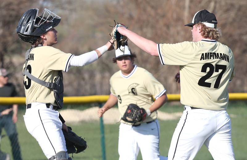 Sycamore catcher Kyle Hartmann congratulates pitcher Jimmy Amptmann after a strikeout during their game against Kaneland Thursday, May 4, 2023, at Kaneland High School.