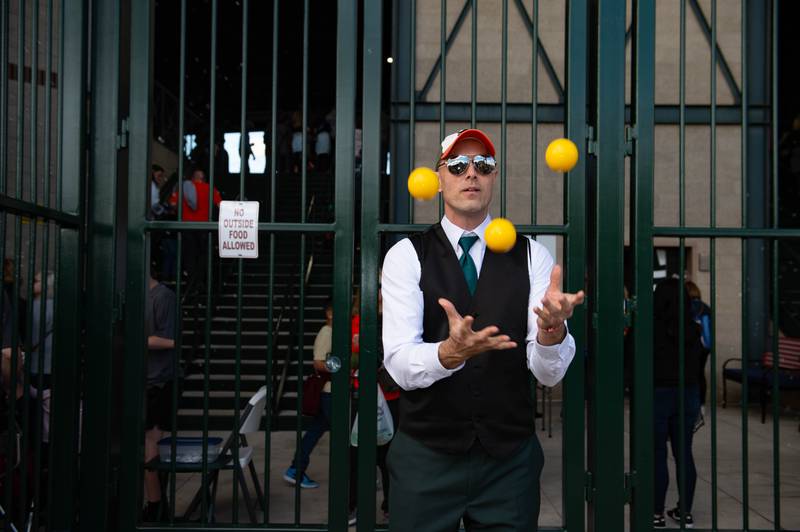 Matthew the juggler entertains fans while they are waiting to get into the stadium prior to the Joliet Slammers home opener Friday May 10, 2024 at Duly Health and Care Field in Joliet