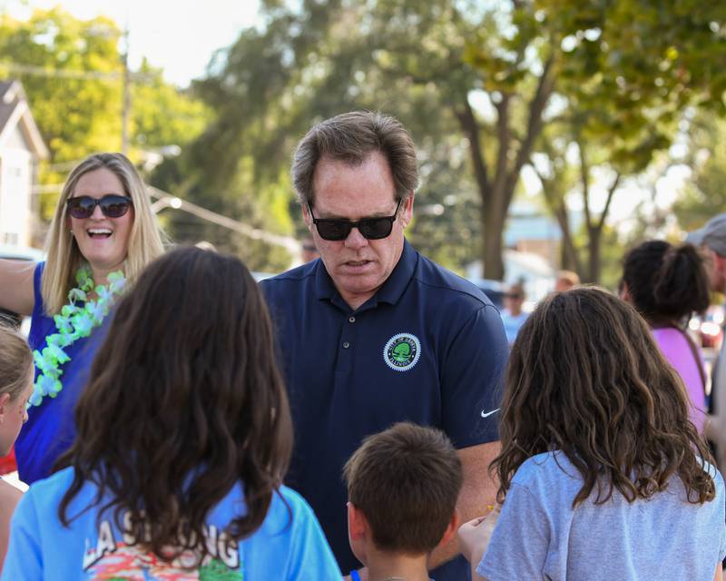 Geneva Mayor Kevin Burns hands out candy during the Geneva High School Homecoming Parade on Friday, Sept. 26, 2025, along State Street downtown.