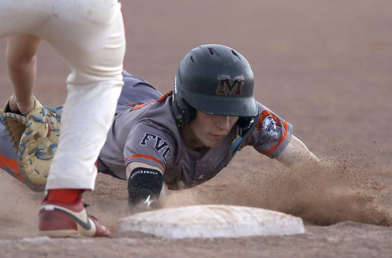 McHenry's Jay Adams dives back to first base during a Fox Valley Conference baseball game against Huntley on Tuesday, May 8, 2026, at Huntley High School.