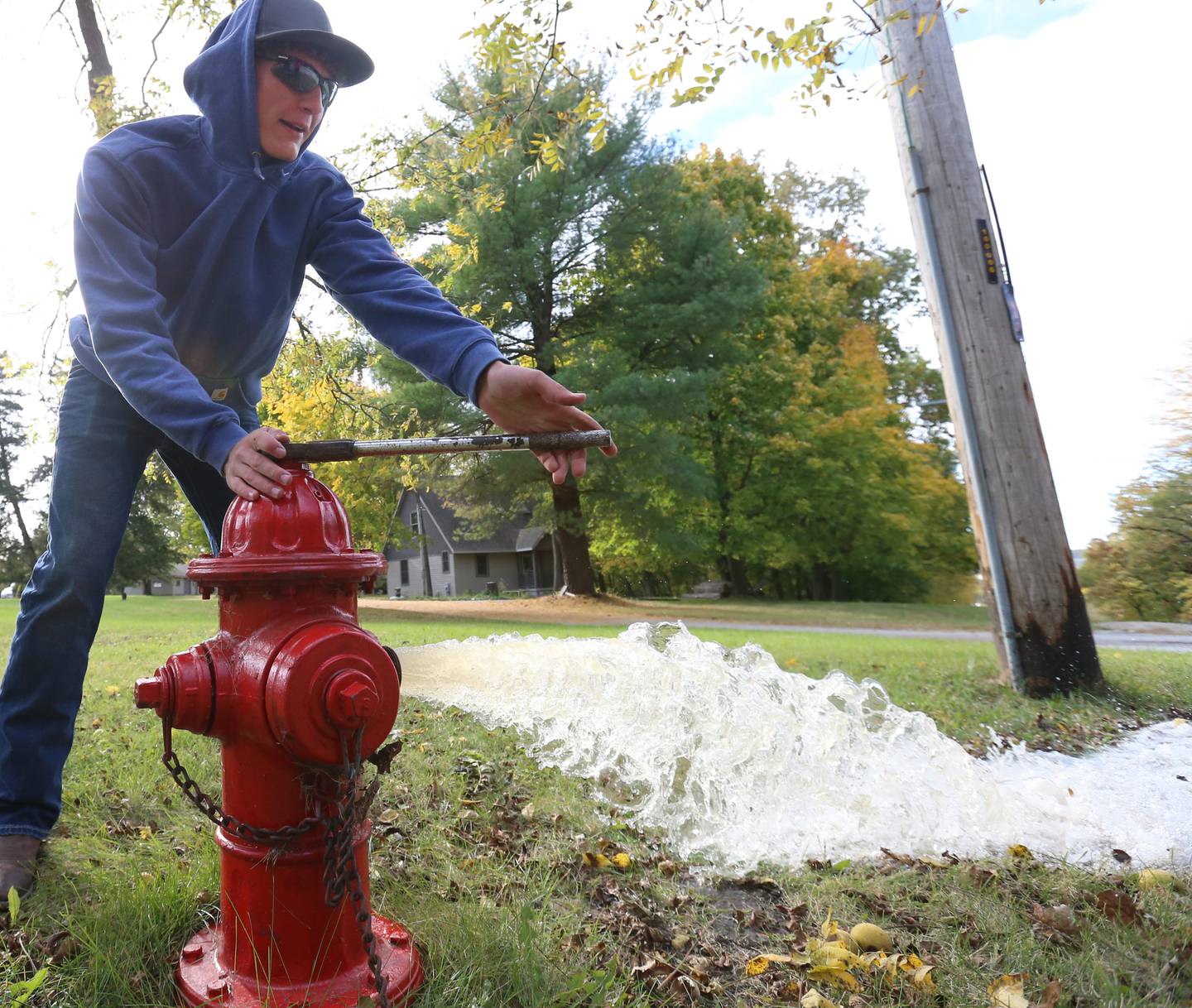 Utica firefighter Nolan Hamilton, flushes a fire hydrant at the top of Clarks Hill on Monday Oct. 17, 2022 in Utica. Utica has over 120 fire hydrants throughout the village. Each hydrant is mapped out using a map with geographic information system (GIS) software that allows firefighters to see how many hydrants would be needed to fight a large fire.