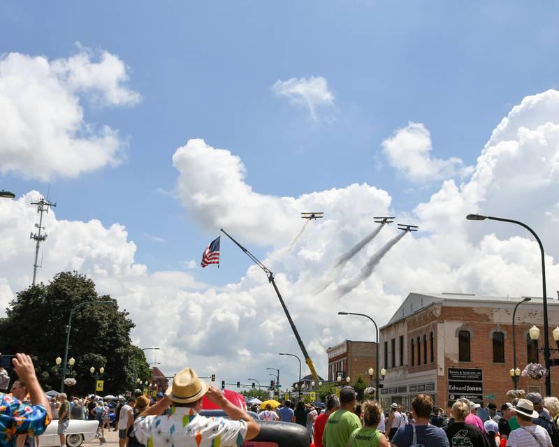 A fly overtakes place during the opening ceremony of the Turning back time car show held on Sunday July 27, 2025, in downtown Sycamore.