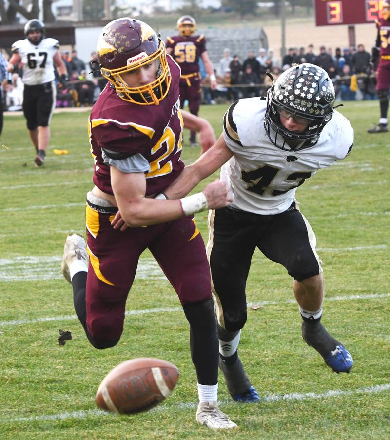 Stockton's Jack Mensendike (24) reaches for a pass as Lena-Winslow's Alec Schlichting (43) defends in 1A semifinal action in Stockton on Saturday, Nov. 22, 2025.