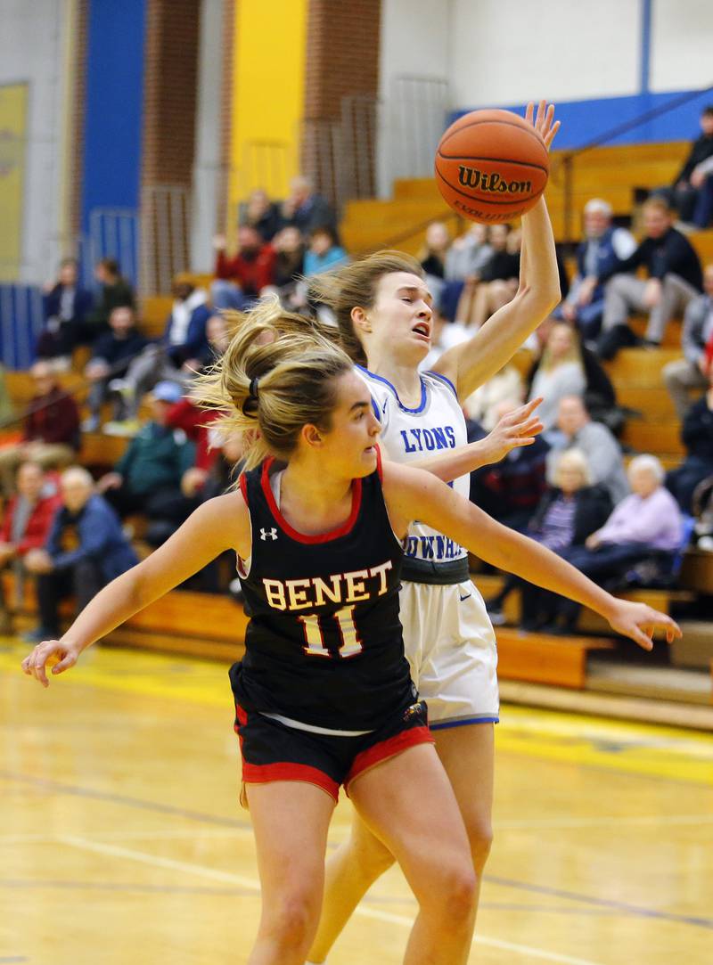 Benet's Sadie Sterbenz (11) fouls Lyons' Ella Ormsby (20) during the girls varsity basketball game between Benet Academy and Lyons Township on Wednesday, Nov. 30, 2022 in LaGrange, IL.