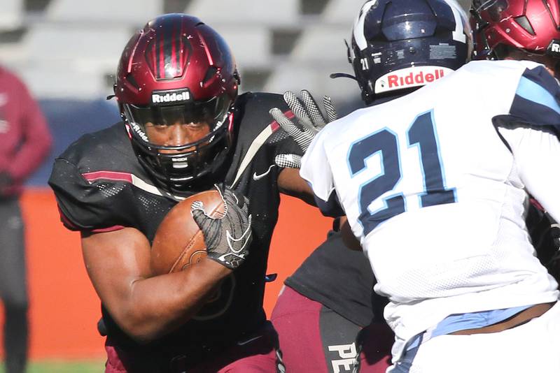 Peoria's Malachi Washington tries to get by Nazareth's Lesroy Tittle during their IHSA Class 5A state championship game Saturday, Nov. 26, 2022, in Memorial Stadium at the University of Illinois in Champaign.