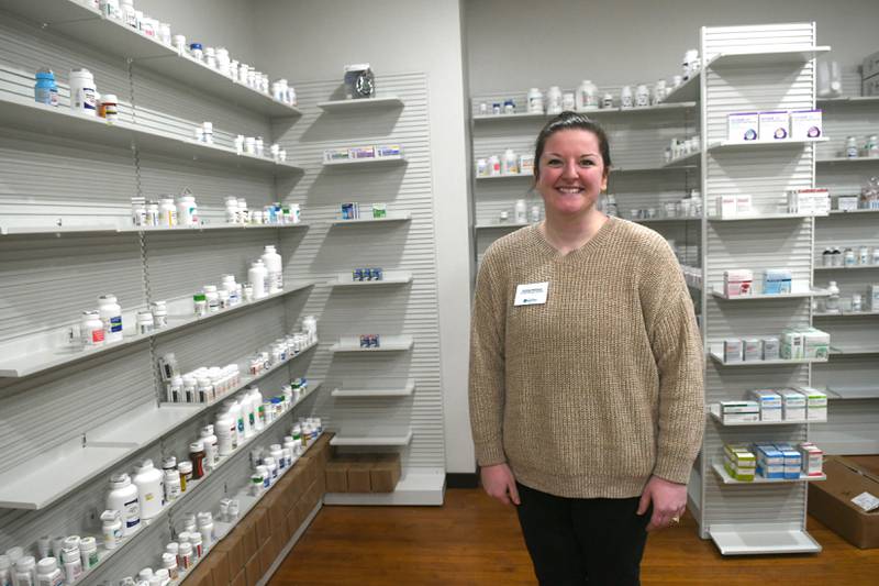 Lindsey Meinsma, a certified pharmacy technician, stands behind the counter at the new Mt. Morris Pharmacy which opened last week.