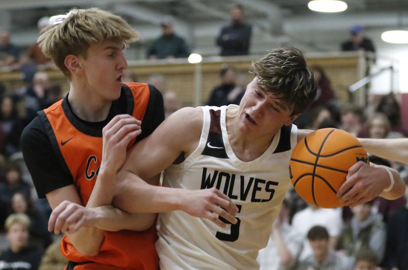 Prairie Ridge's Elijah Loeding elbows Crystal Lake Central's JJ Parrish as he comes down with a rebound during an IHSA Class 3A Prairie Ridge Regional basketball game on Monday, Feb. 24, 2025, at Prairie Ridge High School.