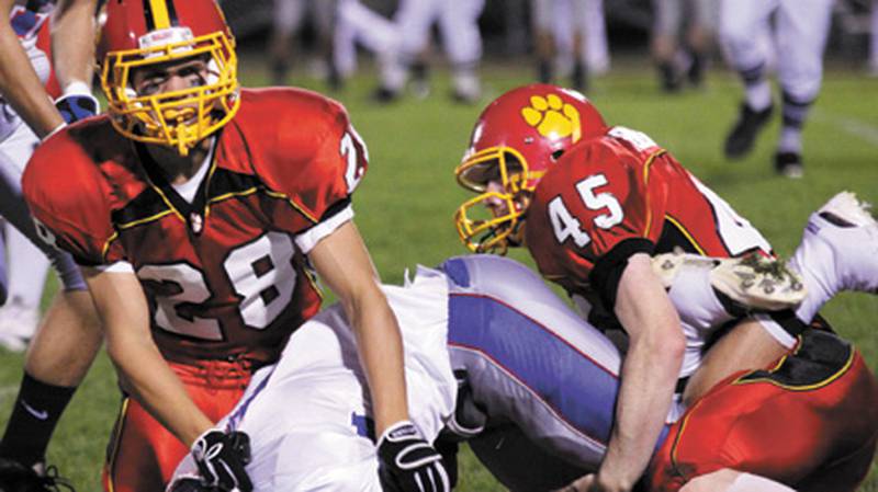 Batavia’s Ben Fornek (28) and Jacob Benner (45) tackle Glenbard South’s Nick Slezak during Friday’s game at Batavia High School. The Raiders defeated the Bulldogs, 19-16, in a Western Sun Conference game. Wendy Kemp – For the Chronicle
