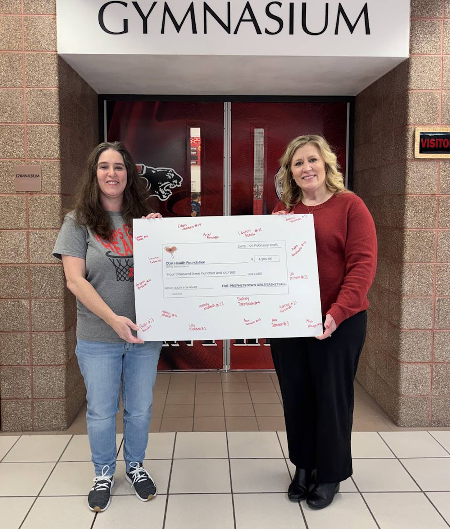 CGH Health Foundation Executive Director Amanda Blaine accepts the donation check from Hoops for Heart event coordinator Jennifer Malone.