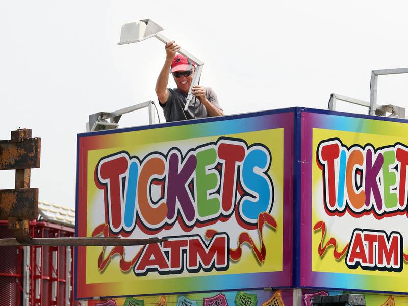 Doug Skinner, of Harvard with Skinner's Amusements attaches a light to a ticket booth before the start of the Lake County Fair on Tuesday, July 25th at the Lake County Fairgrounds in Grayslake. The fair runs from July 26th-30th.
Image by Candace H. Johnson for Shaw Local News Network