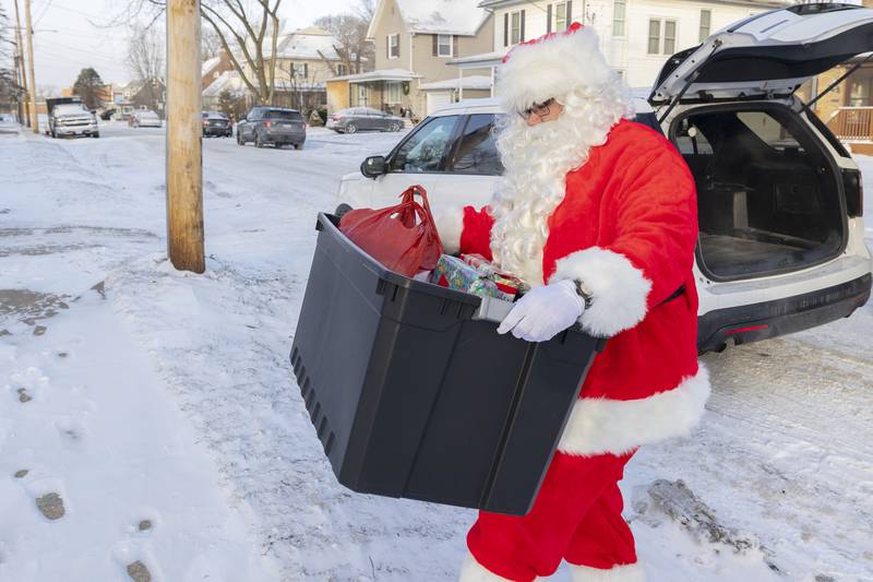 Playing the part of Santa, Jon Colberg hauls in a load of gifts for a Rock Falls fairy Saturday, Dec. 24, 2022. Operation Santa was in full affect on Christmas Eve as members of the Rock Falls Police Department delivered food, gifts and household supplies to families in need.