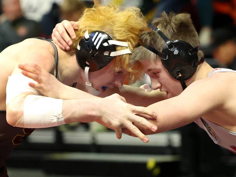 Marian Central Catholic’s Ethan Struck (right) locks up with Lena-Winslow’s Garrett Luke during their Class 1A 152 pound 3rd place match Saturday, Feb. 18, 2023, in the IHSA individual state wrestling finals in the State Farm Center at the University of Illinois in Champaign.