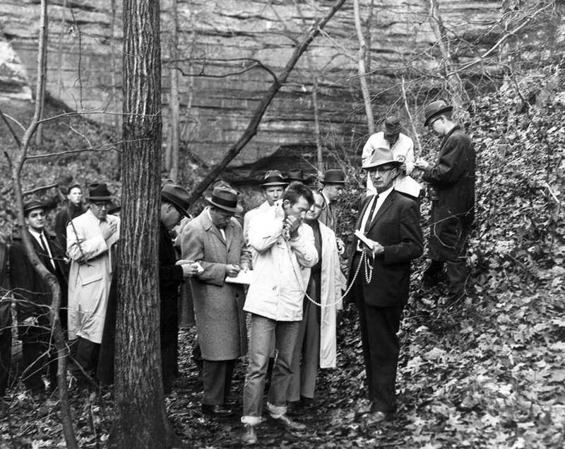 Surrounded by reporters on Nov. 17, 1960, Chester Weger is held in chains by LaSalle County Sheriff Ray Eutsey at Starved Rock State Park's St. Louis Canyon. Weger reenacted the March 14, 1960, killing of three women from Riverside. Weger said he was physically abused into making those admissions.