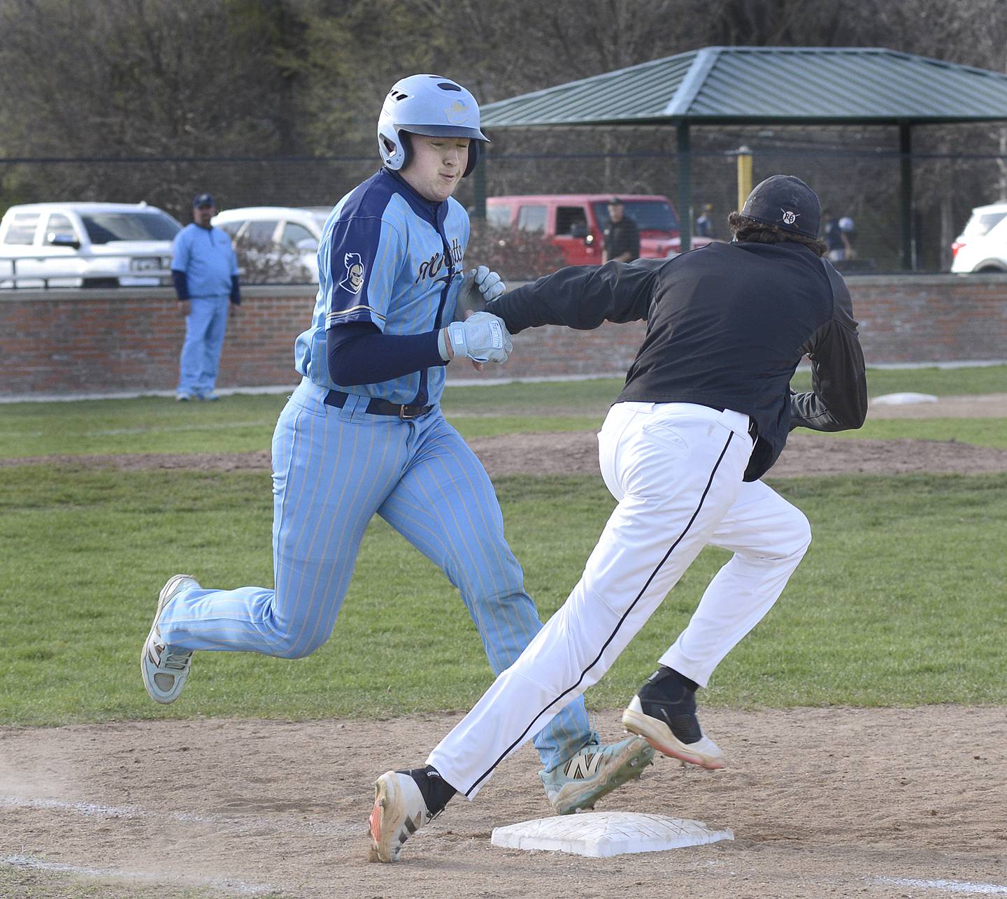 Marquette’s Keaton Davis beats the throw to first base on a dropped third strike Tuesday against Roanoke-Benson/Lowpoint-Washburn at Masinelli Field.