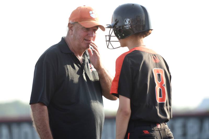 Beecher softball coach Kevin Hayhurst, left, talks to Elena Kvasnicka during a break in the action at the Class 2A State semifinals against Auburn at Peoria's Lousiville Slugger Complex Friday, June 6, 2025.