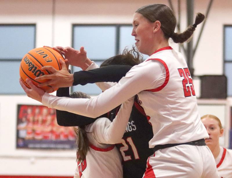 Huntley’s Evelyn Freundt tussles for the ball against Mundelein in varsity girls basketball Komaromy Classic tournament  action on Tuesday, Dec. 30, 2025, at Dundee-Crown High School in Carpentersville.