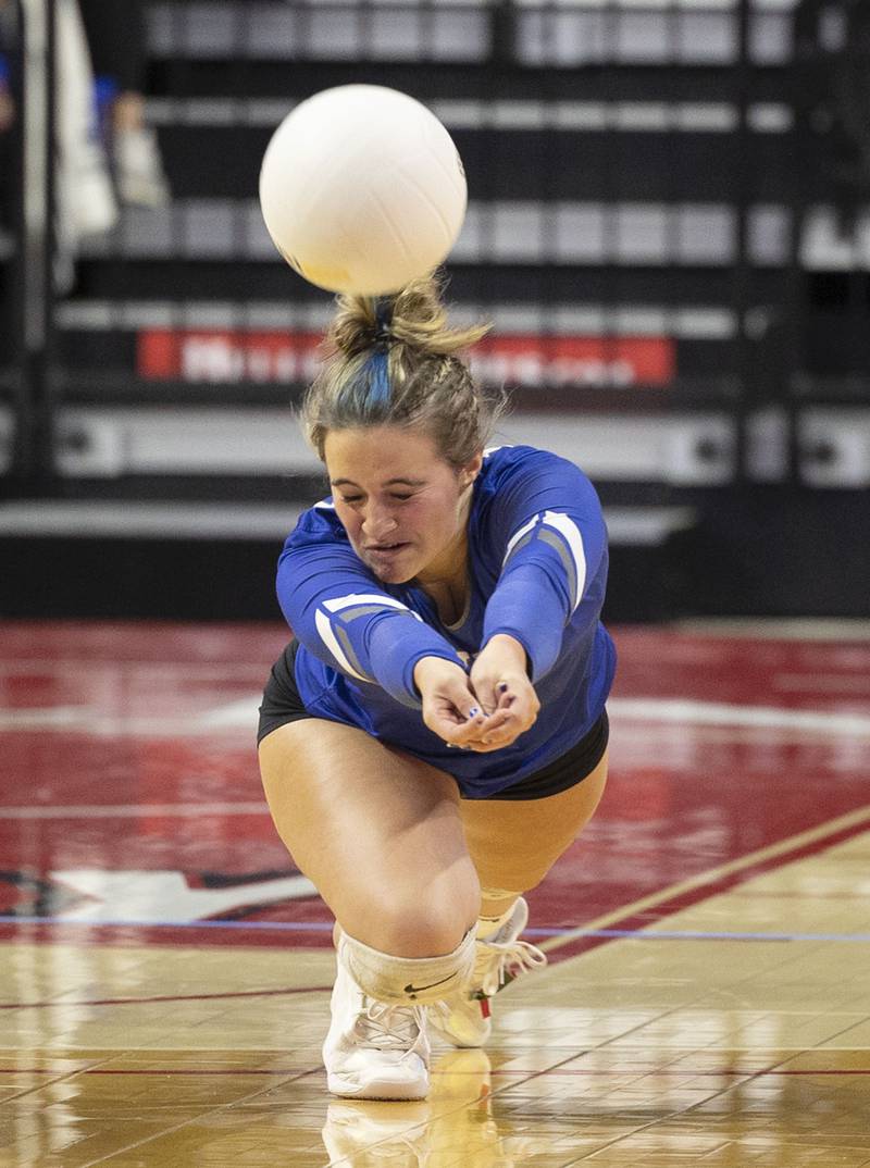 Newman’s Sam Ackman digs a shot Friday, Nov. 11, 2022 in a class 1A volleyball semifinal against Aquin.