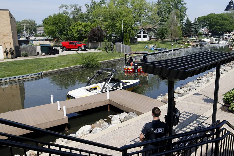 Law enforcement from area departments surround a home on Thursday, June 5, 2025, in the area of Venice Avenue and Court Street in McHenry.