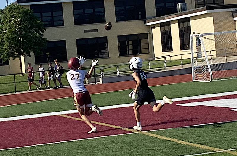 Morris' Jack Wheeler (left) hauls in a touchdown pass during a 7 on 7 competition against Reed-Custer.