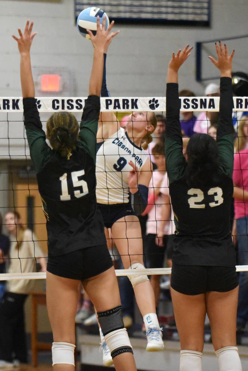 Cissna Park's Addison Lucht, center, looks to send a hit between Bishop McNamara's Jersey Slone, left, and Journey Slone during a game at Cissna Park Wednesday, Oct. 15, 2025.