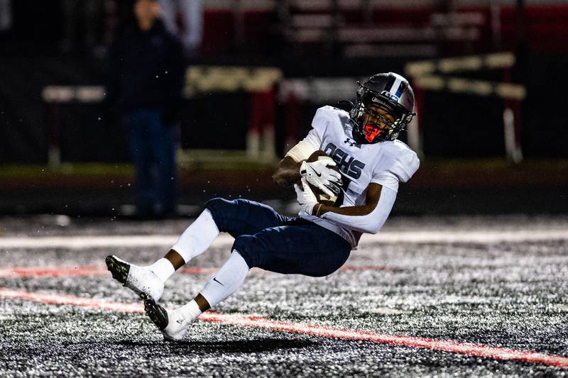 Oswego East's Jamari McKay intercepts a pass intended for Bolingbrook during a game on Friday Oct. 31, 2025 at Bolingbrook High School