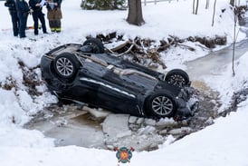 Person hospitalized with possible hypothermia after rollover crash into water near Elgin
