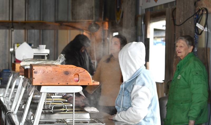 Polo Lions Club volunteers stand in the steam ready to serve burgers, brats and hot dogs at the Spring Hazelhurst Consignment Sale on Saturday, April 4, 2026. The annual auction is held on farm property between Polo and Milledgeville drawing hundreds of farmers from across the region.