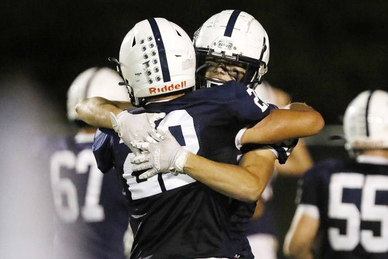 Cary-Grove's Toby Splitt, left, hugs teammate Drew Magel after scoring a touchdown against Crystal Lake Central for their week 3 football game at Cary-Grove High School on Friday, Sept. 10, 2021 in Cary.