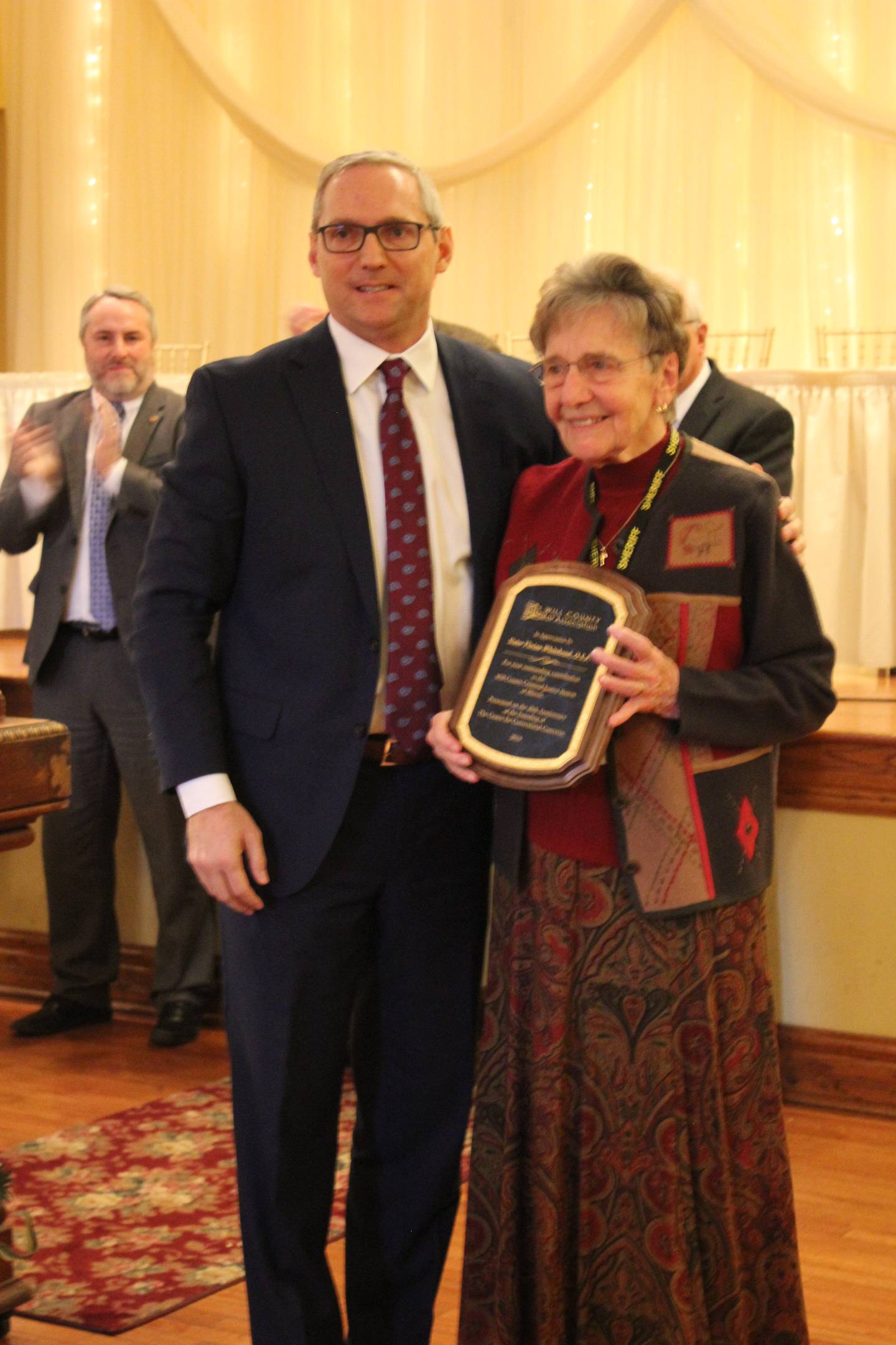 The Will County Bar Association honors Sister Vivian Whitehead for 40 years of service to the Center for Correctional Concerns, which she fou she founded in 1979. Christian Spesia, president of the Will County Bar Association at the time, is seen with Whitehead.