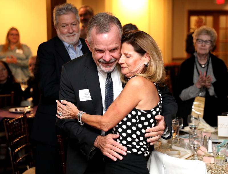 Kristie Dienst hugs her husband, Bruce, after being announced as the 2023 Geneva Chamber of Commerce Wood Award winner during the chamber’s annual dinner and awards at Riverside Receptions in Geneva on Thursday, Nov. 2, 2023.