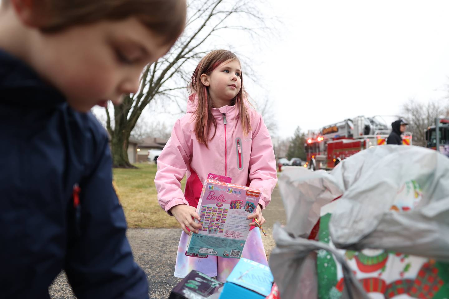 Alexa Jenicek, 8, holds a Barbie doll donated by the non-profit charity Lockport Love. The Jenicek family was one of seven families that received gifts from the non-profit Lockport Love charity on on Saturday, Dec. 10, 2022, in Lockport.
