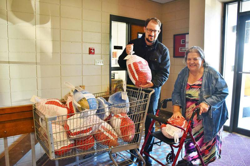 The Rev. Dustin Lyon and Bessie Chronopoulos of St. George Greek Orthodox Church pose for a photo with the 12 frozen turkeys the church's Greek Orthodox Ladies Philoptochos Society donated to WLBK Radio's Let's Talk Turkey fundraiser benefiting The Salvation Army on Friday, Nov. 22.