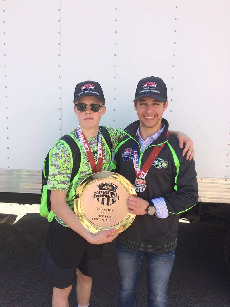 Matt Romer (left) and Nick Addante hold the 2017 national championship plaque.
