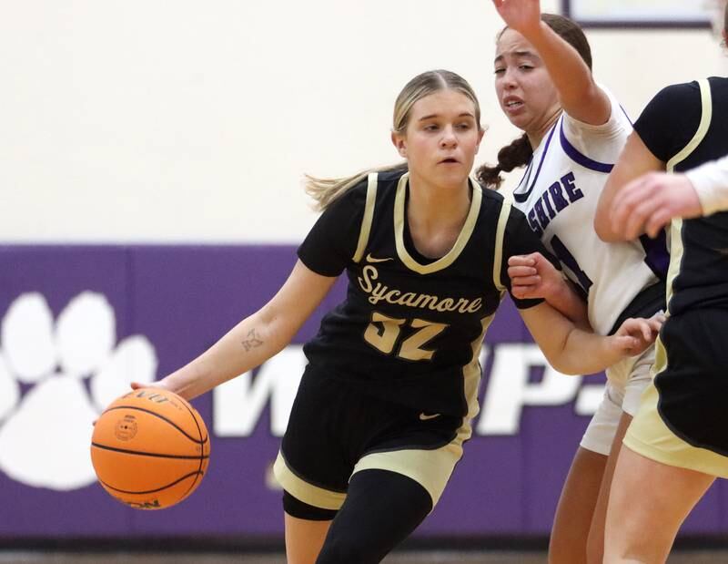 Hampshire’s Mikala Amegasse, right, defends as Sycamore’s Quinn Carrier drives with he ball in varsity girls basketball on Friday, Jan. 3, 2025, at Hampshire High School in Hampshire.