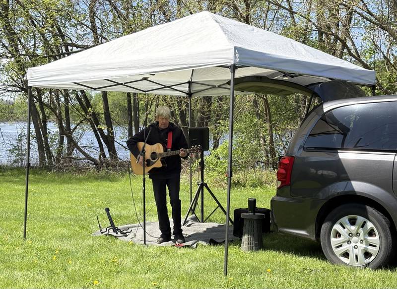 Todd Witek performs during a tribute to late local musician Kevin Kramer at the 10th annual Perfectly Flawed Earth Day cleanup at the I&M Canal’s Lock 14 on Saturday, April 18, in La Salle.