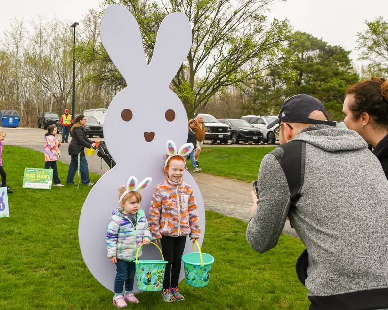 Kyle Peterson of Western Springs takes a photo of his daughters Lydia Peterson, 3, and Melanie Peterson,7, before taking part in the Easter egg hunt on Saturday April 18, 2025, held at Berens Park in Elmhurst.