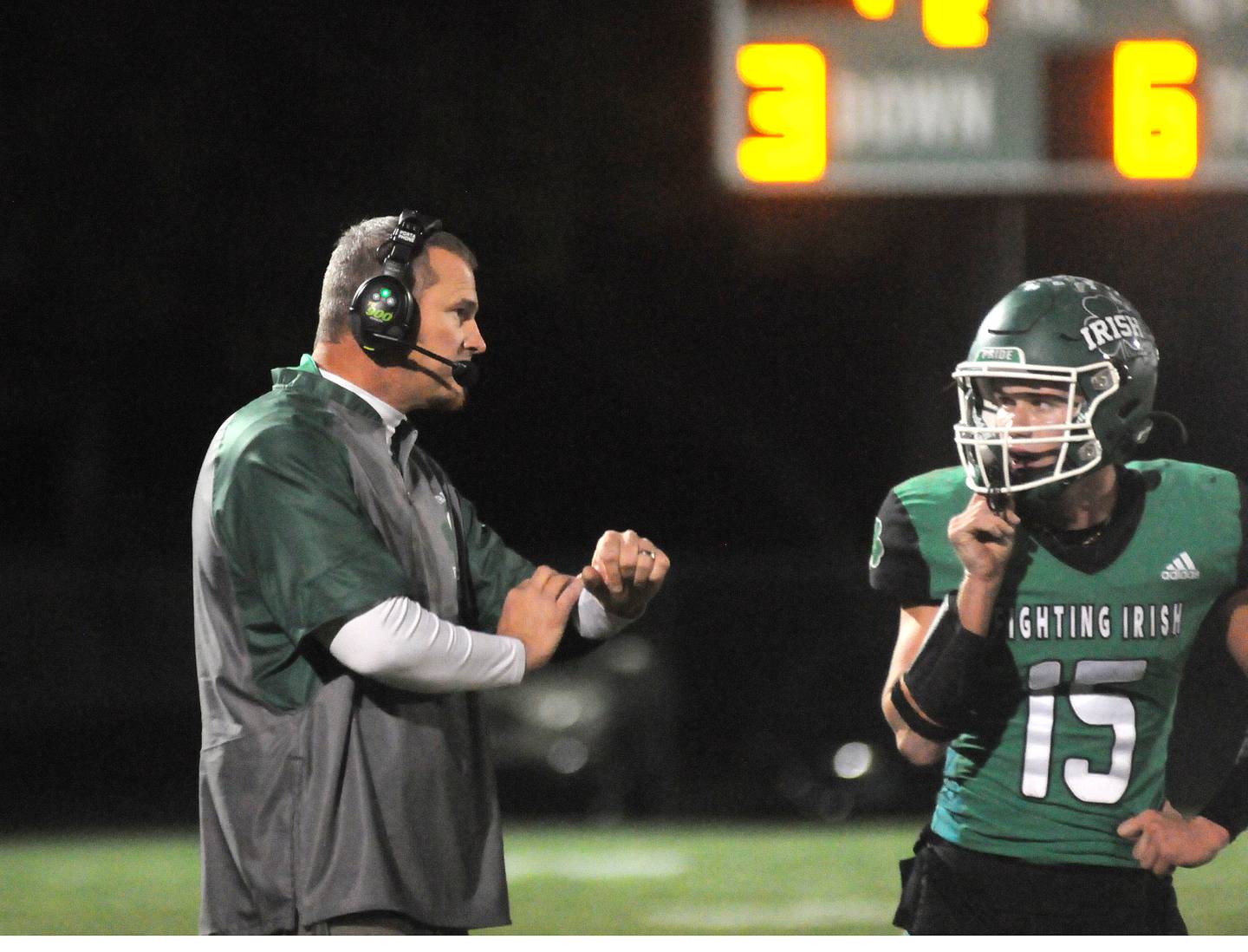 Seneca head coach Terry Maxwell talks with his quarterback, Paxton Giertz (15), on Friday, Oct. 24, 2024, in Seneca.