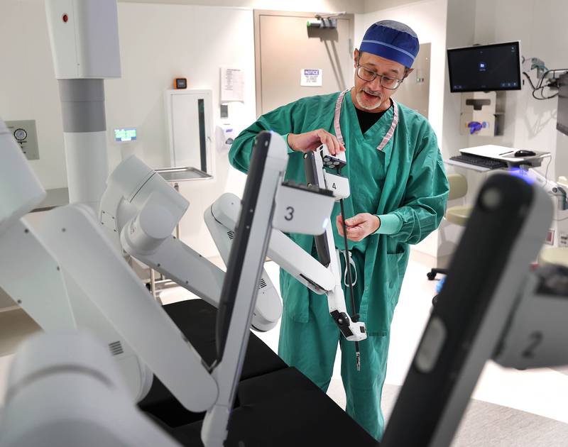 Dr. Jack Wagoner, associate chief medical officer at Northwestern Medicine Kishwaukee Hospital, slides an attachment into place on the da Vinci Xi robotic surgical system Tuesday, Oct. 28, 2025, in one of the operating rooms at the hospital in DeKalb. The hospital recently celebrated its 2,000th successful robotic-assisted surgery.