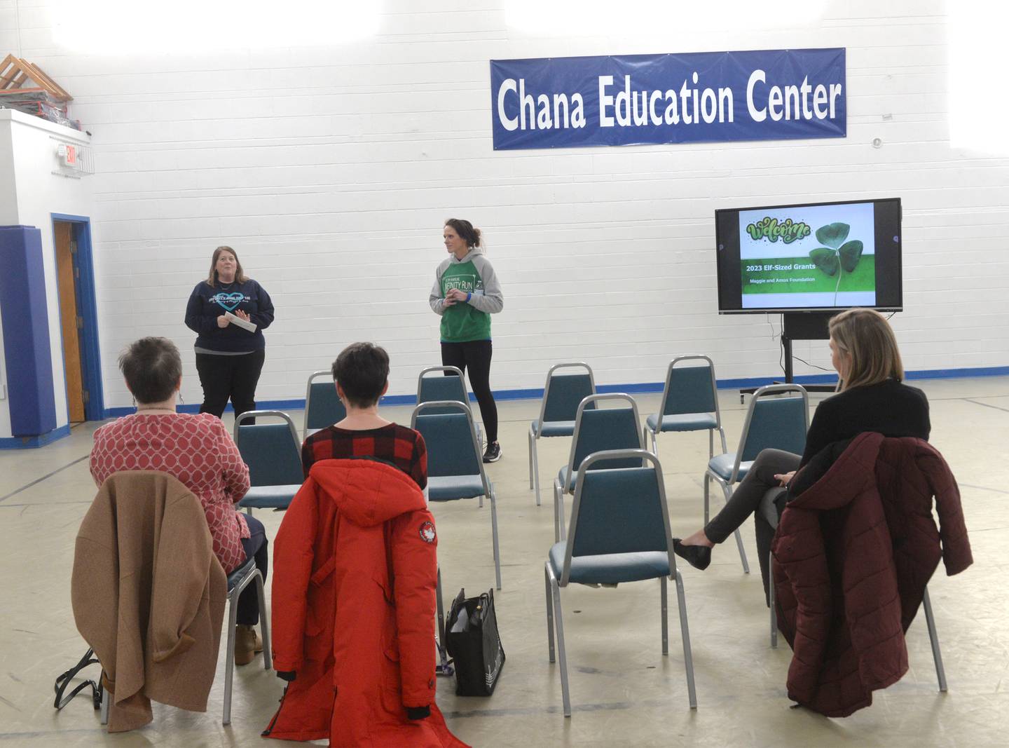 Chana Education Center's Stephane White (left) and Lynn Kalnins speak at the presentation program for the recipients of the 2023 Maggie & Foundation's educational grants.