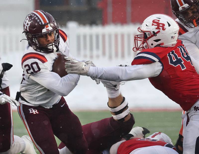 Brother Rice's Jaylin Green tries to break free from St. Rita's Jacob Fleming Wednesday, Dec. 3, 2025, during their IHSA Class 7A state chamionship game in Huskie Stadium at Northern Illinois University in DeKalb.