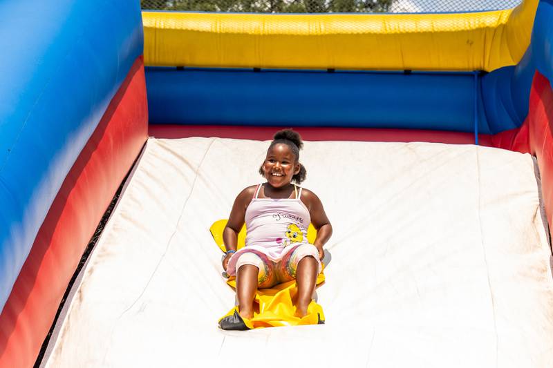 Joliet resident Mackenzie Sherrod (7) goes down the slide during Kidz Fest in Joliet on Aug. 3, 2024.