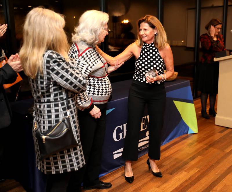 Kristie Dienst (right) is congratulated by her sister Konnie Sherry and her mom, Jo Anne Granquist, after being announced as the 2023 Geneva Chamber of Commerce Wood Award winner during the chamber’s annual dinner and awards at Riverside Receptions in Geneva on Thursday, Nov. 2, 2023.