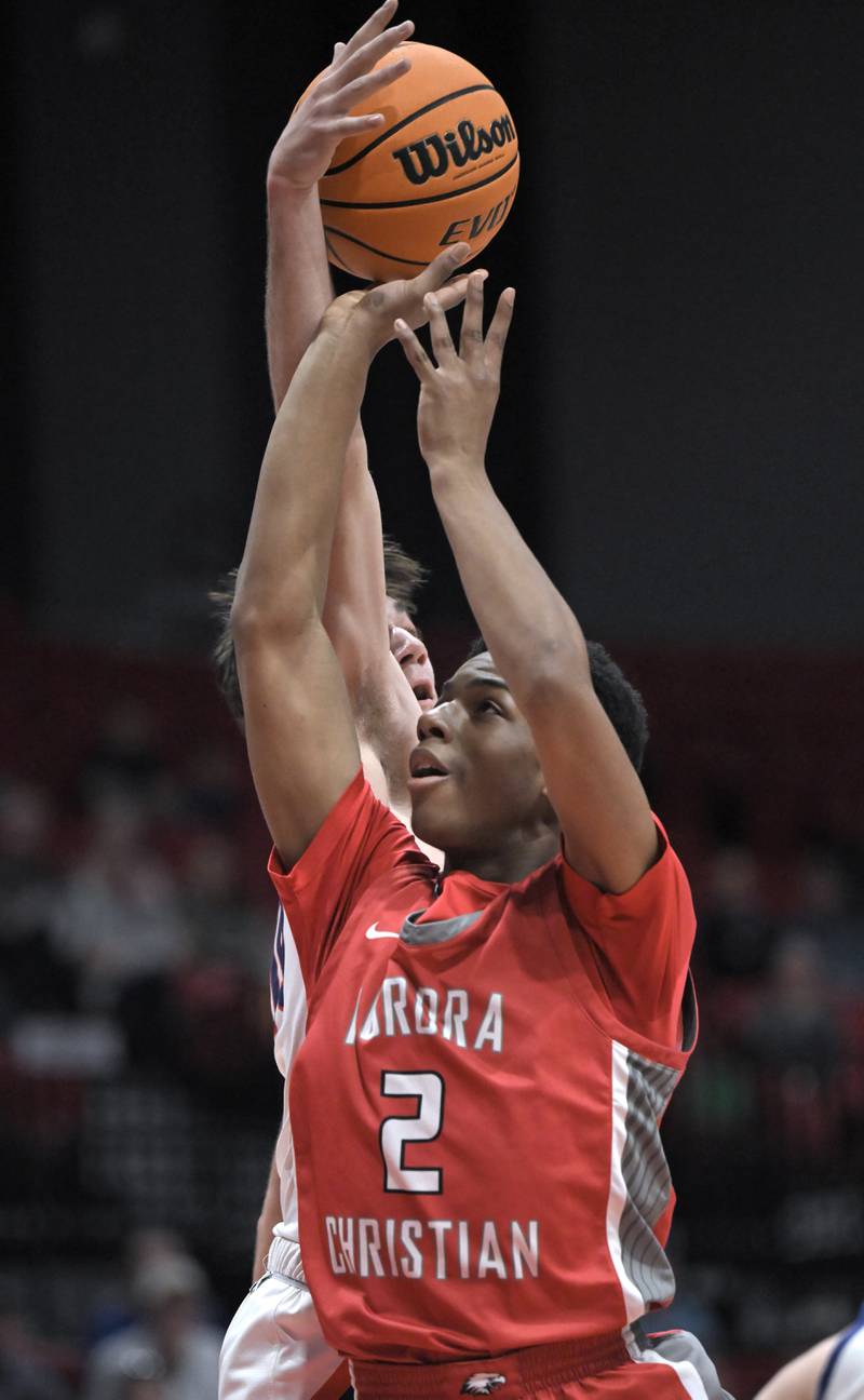 Aurora Christian’s James Baker has his shot blocked by Eastland’s Zyacn Haverland in a IHSA Class 1A boys basketball supersectional at Northern Illinois University in DeKalb on Monday, Mar. 10, 2025.