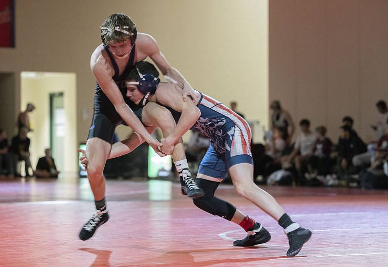 Morrison’s Cael Wright grabs Dixon’s Jack Ragan in the 120 pound weight class in the Class 1A wrestling sectionals at Oregon.