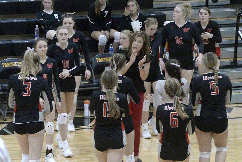 Woodland volleyball coach Michelle Pitte encouragers her Warriors during a timeout Thursday, Aug. 25, 2022, in Granville.