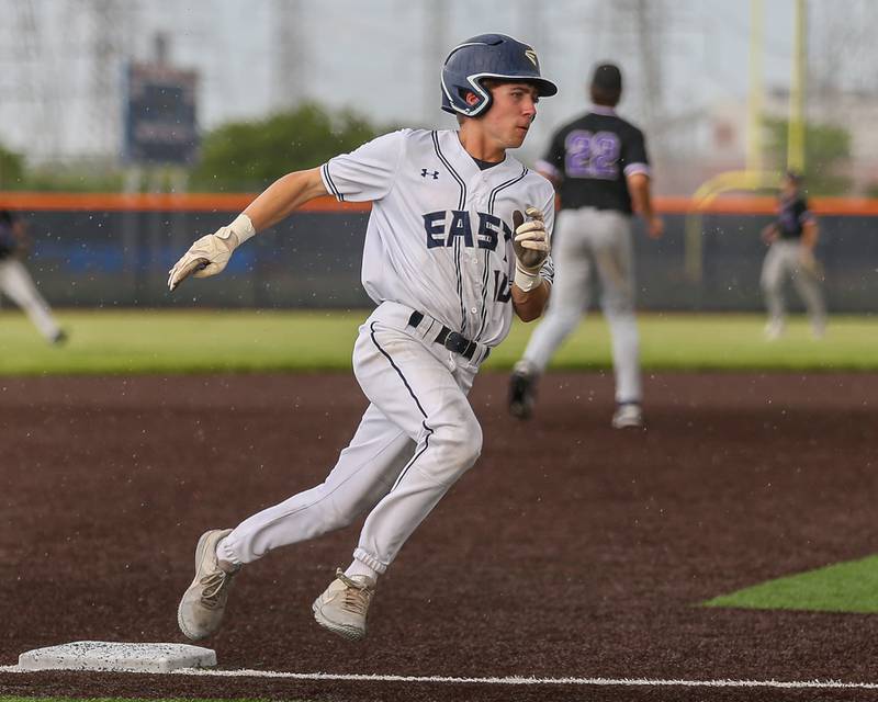 Oswego East's Andy Lewis (10) rounds third base during Class 4A Romeoville Sectional semifinal between Oswego East at Downers Grove North.  May 31, 2023.